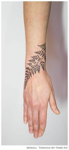 a person's hand with a tattoo on it and the words moguli, art london, united kingdom follow