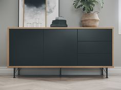 the sideboard is black and has two drawers