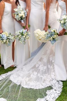 the bridesmaids are holding their bouquets and posing for a photo on the grass