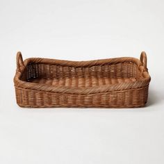 an empty wicker basket with handles on a white background