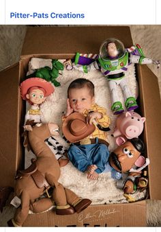 a baby in a toy story box surrounded by farm animals and other figurines