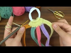 someone is crocheting together with yarn and knitting needles to make an ornament