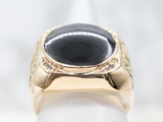 Sophisticated, bold, and eye-catching, this black onyx statement ring features a great size and shape on the finger! Ornate gold scrollwork creates a handsome setting for the bold black onyx center. We love the ornate design of this ring, and the way the bezel 18-karat gold frames the rich, black center stone.Metal: 18K Yellow GoldGem: Black OnyxGem Measurements: 16.6 mm, RoundRing Size: 10.50Marks: “18K G0207” Stamped on the inside band Yellow Gold Amethyst Ring, Garnet And Diamond Ring, Gold Amethyst Ring, Gold Frames, Ornate Design, Pearl And Diamond Ring, Gold Signet Ring, Tanzanite Ring, Diamond Cocktail Rings