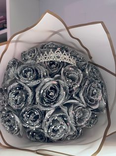 a bridal bouquet made out of rolled up silver paper and crystal stones in the shape of roses