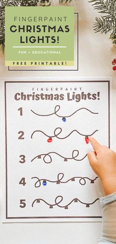 a child's hand is drawing christmas lights on a sheet of paper that says fingerpaint christmas lights