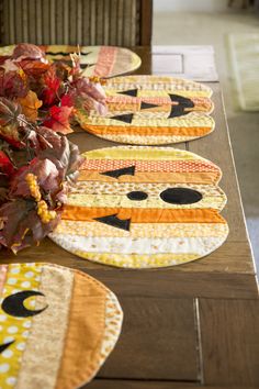 the table is set with placemats made to look like cats and pumpkins