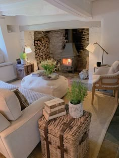 a living room filled with furniture and a fire place in the middle of the room