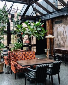 a living room filled with furniture and plants