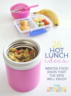 a pink lunch box filled with food next to a banana