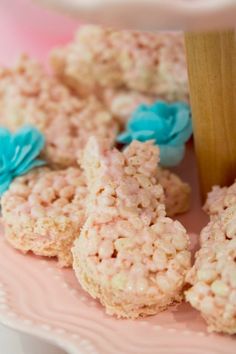 rice krispy treats are on a pink plate