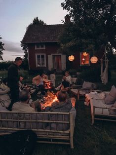 a group of people sitting around a fire pit