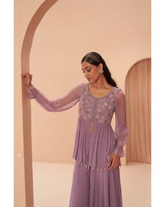 Lilac Breeze Sharara Set - Parul Gandhi Elevate your style with a beautiful peplum sharara set featuring delicate floral embroidery adorning the torso. This ensemble exudes sophistication, combining the trendy peplum silhouette with intricate floral details for a perfect balance of elegance and modern flair. Included in Purchase: Sharara Top, Pant & Dupatta Product Specification Color: Lavender Fabric: Georgette Neckline: Scoop Occasion: Bridal, Engagement, Formal Event Designer: Parul Gandhi Wo Lavender Sharara, Peplum Sharara, Lilac Lehenga, Plazzo Dress, Kurta And Sharara Set, Kurta And Sharara, Sharara Designs, Indian Bridal Lehenga, Embroidered Bodice