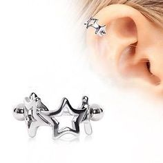 two silver stars are attached to an ear