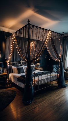 a bedroom decorated in black and white with string lights on the ceiling, bed frame