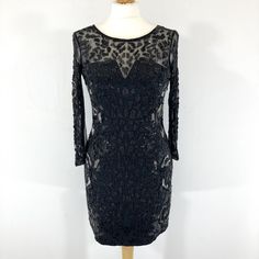 Stunning beaded midi dress by AllSaints in heavily embellished sheer black fabric. The dress a large amount of beading on the front and back, with high quality heavy weight beads and sequins that catch the light when the dress moves. It has a sheer panel on the back with a symmetrical beaded pattern Zip fastening.  In good condition, with a few unnoticeable missing beads. Measurements  Bust: 32" Waist: 28" Length: 32" Sleeves: 17" Festive Embellished Glamorous Midi Dress, Glamorous Embellished Festive Midi Dress, Elegant Midi Dress With Sheer Back For Party, Evening Party Embellished Midi Dress, Evening Embellished Midi Party Dress, Embellished Midi Dress For Evening Party, Elegant Embellished Mesh Evening Dress, Elegant Embellished Mesh Dress For Night Out, Embellished Long Sleeve Mesh Dress For Night Out