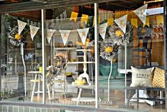 a store window with yellow and white decorations