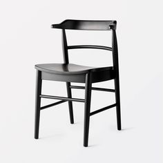 a black wooden chair on a white background with the seat up and back turned down