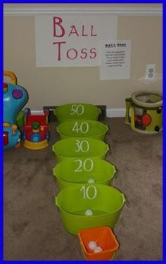 there are many green buckets on the floor with numbers in them and one is for children