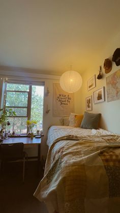 a bed sitting under a window next to a desk