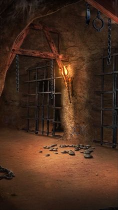 a dimly lit room with rocks and chains on the floor