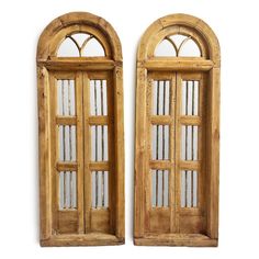 two wooden doors with arched windows on each side and one has glass in the middle