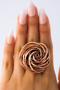 "DON 925's master silversmiths handcrafted this unusual ring with genuine copper. Make a statement with this gorgeous ring. Diameter Size: 3.8 cm (1.50 inches) Ring rises 1.8 cm (0.70 inches) above the finger. Band width: 6 mm (0.23 inches) Weight: 31.2 grams Some people say copper helps ease the aches and pains of stiff and sore joints. These rings are made of genuine solid copper and an alloy metal for soldering (The silver detail you see is evidence of the soldering - Not an imperfection in t Handmade Elegant Copper Rings, Elegant Rose Gold Copper Rings, Handmade Rose Gold Flower Ring, Wire Accessories, Copper Wire Ring, Jewlery Rings, Big Statement Rings, Finger Band, Wire Jewelry Patterns