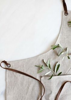 two aprons with olive branches on them