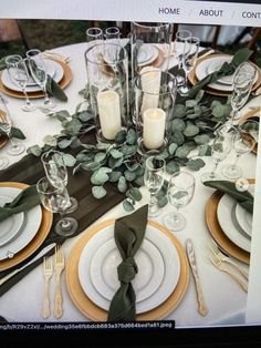 an image of a table setting with place settings and greenery on the centerpiece