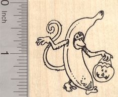 a rubber stamp with an image of a monkey holding a pumpkin