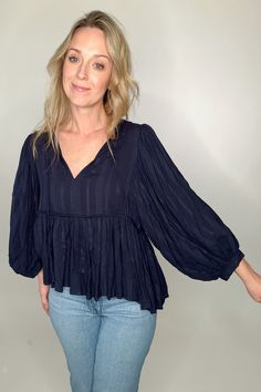 Introducing the Breezy Navy Blouse, a navy blue boho blouse with intricate ties at the neck and textured knit fabric that creates a beautiful billowy silhouette. Details: Billow sleeves V-neck with necktie strings Piping details under bust Fit: designed for an over size fit, if you want more fitted we suggest sizing down. Amber is 5'6" modeling size small. Content: Vicose and linen blend Imported. Bohemian Textured Knit V-neck Top, Bohemian Long Sleeve Textured Knit Tops, Chic Blue Billowy Tops, Navy Textured Knit Long Sleeve Tops, Chic Billowy Blue Tops, Peasant Style Rayon Tops For Fall, Fall Peasant Tops In Rayon, Fall Peasant Style Rayon Tops, Navy Chic Blouse For Spring