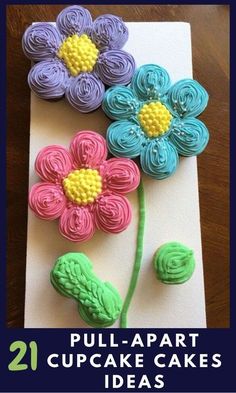 three flowers made out of fondant sitting on top of a piece of paper