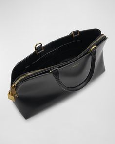 Saint Laurent "Sac de Jour" duffel bag in leather    Rolled top handles     Detachable, adjustable crossbody strap    Can be worn as a top handle or crossbody bag     Open top     Interior, zip compartment with padlock accent, slip compartment, and one slip pocket     Feet protect bottom of bag     Approx. 8.9"H x 14.3"W x 4.7"D    Professional cleaning recommended    Made in Italy Luxury Leather-lined Saddle Bag For Work, Luxury Leather-lined Double Handle Shoulder Bag, Saint Laurent Jamie Bag, Black Saffiano Leather Bag With Handle Drop, Luxury Leather-lined Top Handle Bag, Leather Roll, Tote Bag Leather, Top Handle, Duffel Bag