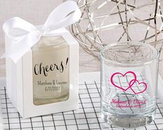 two personalized wedding gifts on a table with a basket and vase in the background