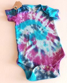 Tie Dye Baby Body Suit , Colorful Baby T Shirt With 3 Snap Crotch Blue Pink Purple Swirls Size 12-18 Months , Summer Baby One Piece   Baby will look and feel cool this Summer in this adorable cotton one piece bodysuit that was hand dyed using colors including aqua blue  ,  indigo , purple , and pink. Super cute short sleeved shirt for baby has a three snap closure at the crotch for easier dressing and diaper changes. This one piece snap shut top is infants size 12-18 Months . Bodysuit has been w Colorful Baby, Small Business Gifts, Blue Pink Purple, Purple Swirl, Baby Colors, Big Gifts, Baby T Shirts, One Piece Bodysuit, Baby T Shirt