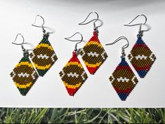 four beaded earrings with different designs on them