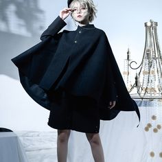 A black cape cloak that looks like a British knight. Pair it with short pants and black tops to create a boyish black knight outfit. Just put on a cape cloak to create a full atmosphere. Why not be invited into the world of knightly tales? 
 
 
 Size 
 
 S size 
 
 Length: 67cm-82cm 
 
 M size 
 
 Length: 69cm-84cm 
 
 L size 
 
 Length: 72cm-85cm 
 
 
 
 
 
 Material 
 
 Nylon 
 Polyester 
 Acrylic 
 
 
 Model worn 
 
 Wearing size 
 
 S size 
 
 Model dimensions 
 
 Height: 160cm Gothic Cape Outerwear For Costumes, Gothic Cape Outerwear For Costume Party, Gothic Cape For Costume Party In Fall, Vampire Style Cape For Costume Party In Winter, Gothic Long Sleeve Cape For Fall, Vampire Cape For Winter Costume Party, Vampire Style Cape For Costume Party And Winter, Vampire Cape For Costume Party In Winter, Black Long Sleeve Cape For Halloween