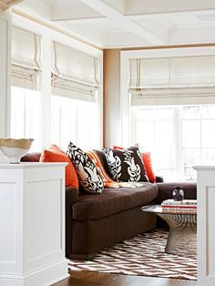 a living room filled with furniture and lots of windows