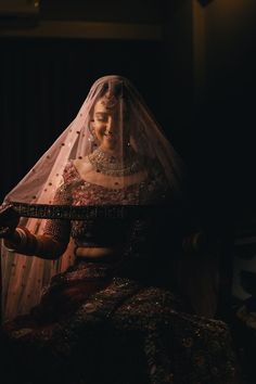 a woman wearing a veil and holding a knife