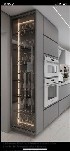 an image of a modern kitchen setting with wine glasses on the glass door and stainless steel appliances