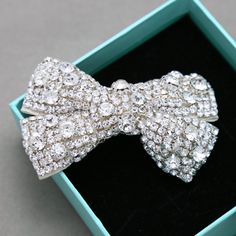 "Use this silver tone bow crystal applique on bowtie, shoe clips, bridal decoration,wedding craft,hair craft,brooch,hair comb,clip,ring pillow,sash,hair clip,headbands, bridal jewelries/accessories, costumes, evening gowns,shoes clips,wedding invitation items,dress,bouquet wrap,wedding decoration,hair accessory,sash craft, fascinating hat, jewelry,cake decoration, clutch bags etc. Properties: glass clear rhinestone crystals Color: silver Shape: bow shape size: 8cm, 3.1\" ------------------------ Silver Jewelry With Decorative Bow For Wedding, Silver Wedding Jewelry With Decorative Bow, Elegant Bow Shoe Clips For Wedding, Elegant Wedding Shoe Clips With Bow, Silver Crystal Hair Accessories For Party, Silver Crystal Hair Accessories For Wedding, Elegant Silver Hair Accessories With Rhinestones, Wedding Crystal Hair Accessories With Rhinestones, Elegant Silver Crystal Hair Accessories