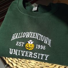 Halloweentown embroidered sweatshirt, Vintage spooky season sweatshirt, embroidered halloween university sweatshirt, halloweentown university sweatshirt, Spooky pumpkin ghost sweatshirt, Vintage halloweentown university crewneck I've included images showing the design on a Forest Green Sweatshirt, please message me for specific sweatshirt colour requests/a request for changing the embroidery colour. Check out our Shop filled with so many Designs! https://www.etsy.com/uk/shop/TahikoStitch ⬅️⬅️⬅️ Fall School Spirit Tops With Embroidered Text, School Spirit Embroidered Tops For Fall, School Spirit Tops With Embroidered Text For Fall, Fall Campus Tops With Embroidered Graphics, Fall Tops With Embroidered Text For School Spirit, Fall School Tops With Embroidered Logo, Fall School Tops With Embroidery, Embroidered Tops For School In Fall, Fall School Spirit Embroidered Sweatshirt