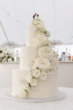 a wedding cake with white flowers on top