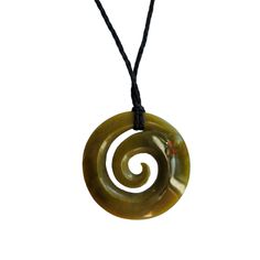 We offer FREE WORLDWIDE SHIPPING and dispatch all orders within 1-2 business days. Our Greenstone Koru Necklace is crafted from a green New Zealand Jade stone with hues of yellow. The carving is symbolic of nature and represents the unfurling frond of the fern - symbolic of hope, growth and new beginnings. Stone: Our Greenstone Koru Necklace is made from 100% Authentic Natural New Zealand Jade. Size: The Greenstone Koru Necklace is available in the below sizes and comes hung on a one size fits a Earthy Necklaces As Gifts, Earthy Round Necklaces For Gifts, Unique Green Carved Necklace, Handmade Symbolic Green Necklace, Green Adjustable Amulet Necklace, Green Symbolic Pendant Necklace, Adjustable Green Amulet Necklace, Adjustable Green Amulet Style Necklace, Green Carved Amulet Necklace