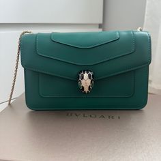 Bnib/Bnwt Bulgari Serpenti Forever Crossbody Bag In Green Calf Leather With Light Gold Chain/Leather Strap. Retails $3400. They’ve Discontinued This Model That Fits An Iphone With A Chain/Leather Strap. Tag Attached, Never Used. Comes In Original Box With Dust Bag, Rain Cover, New Mirror, And Authenticity Card. Serpenti Eyes Are Malachite. 13 Cm H X 22 Cm W X 5 Cm D Come From A Smoke-Free Home. Luxury Wallet On Chain Shoulder Bag, Luxury Green Bag With Chain Detail, Luxury Green Bag With Chain, Luxury Green Chain Bag, Luxury Chain Crossbody Bag, Luxury Wallet On Chain With Detachable Strap, Luxury Chain Bags As Gift, Luxury Chain Bag As Gift, Luxury Evening Bag With Gold-tone Hardware For Gift