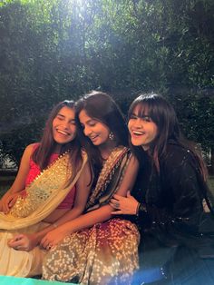 three young women sitting next to each other