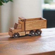 a wooden toy truck sitting on top of a table