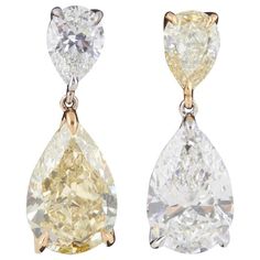 A unique and beautiful pair of earrings -- a rare find! Four fabulous pear shaped diamonds -- alternating yellow and white diamond drops. All 4 diamonds are GIA certified. 6.52 carats of Fancy yellow diamonds, 5.08 carats of white diamonds set in 18k yellow and white gold. (1) GIA 1.03 carat Fancy Yellow, SI1 pear shaped diamond (1) GIA 1.07 carat I color, SI1 clarity pear shaped diamond (1) GIA 5.49 carat Fancy Yellow, VS2 pear shaped diamond (1) GIA 4.01 carat I color, VS1 clarity pear shaped Yellow Diamond Earrings, Dig Jewelry, Yellow Diamond Earring, White Diamond Earrings, Diamonds Earrings, Vintage Drop Earrings, Sweet Accessories, Yellow Diamonds, Bling Earrings