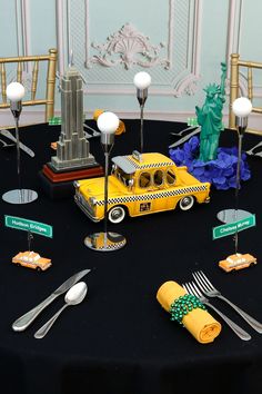 a taxi themed table setting with forks, spoons and utensils