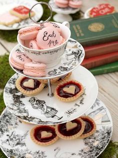 three tiered plates with cookies and pastries on them