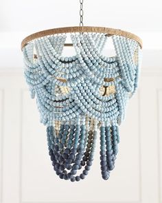 a blue beaded chandelier hanging from a ceiling